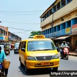 Home 15 가나 현지 교통 이용법 - **A vibrant, bustling street scene in Accra, Ghana, at midday.** The foreground features several bri...